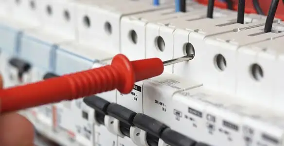Electrical contractor testing circuit breakers during electrical repair in Olive Branch, MS