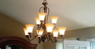 Classic ceiling chandelier installation with warm lighting in Memphis, TN