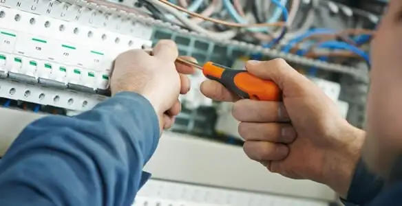 electrical service showing licensed electrician performing electrical panel maintenance and adjustments in Memphis, TN