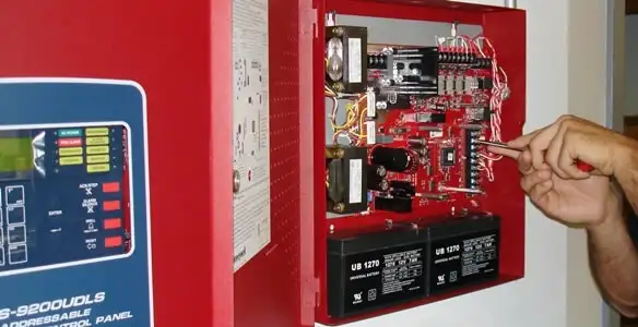 fire alarm installation service showing technician configuring fire alarm control panel in Memphis, TN