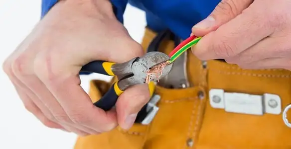 licensed electrician securing electrical wiring with professional tools during service work in Memphis, TN