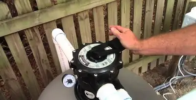 pool pumps service showing professional adjustment of pool pump control system in Memphis, TN